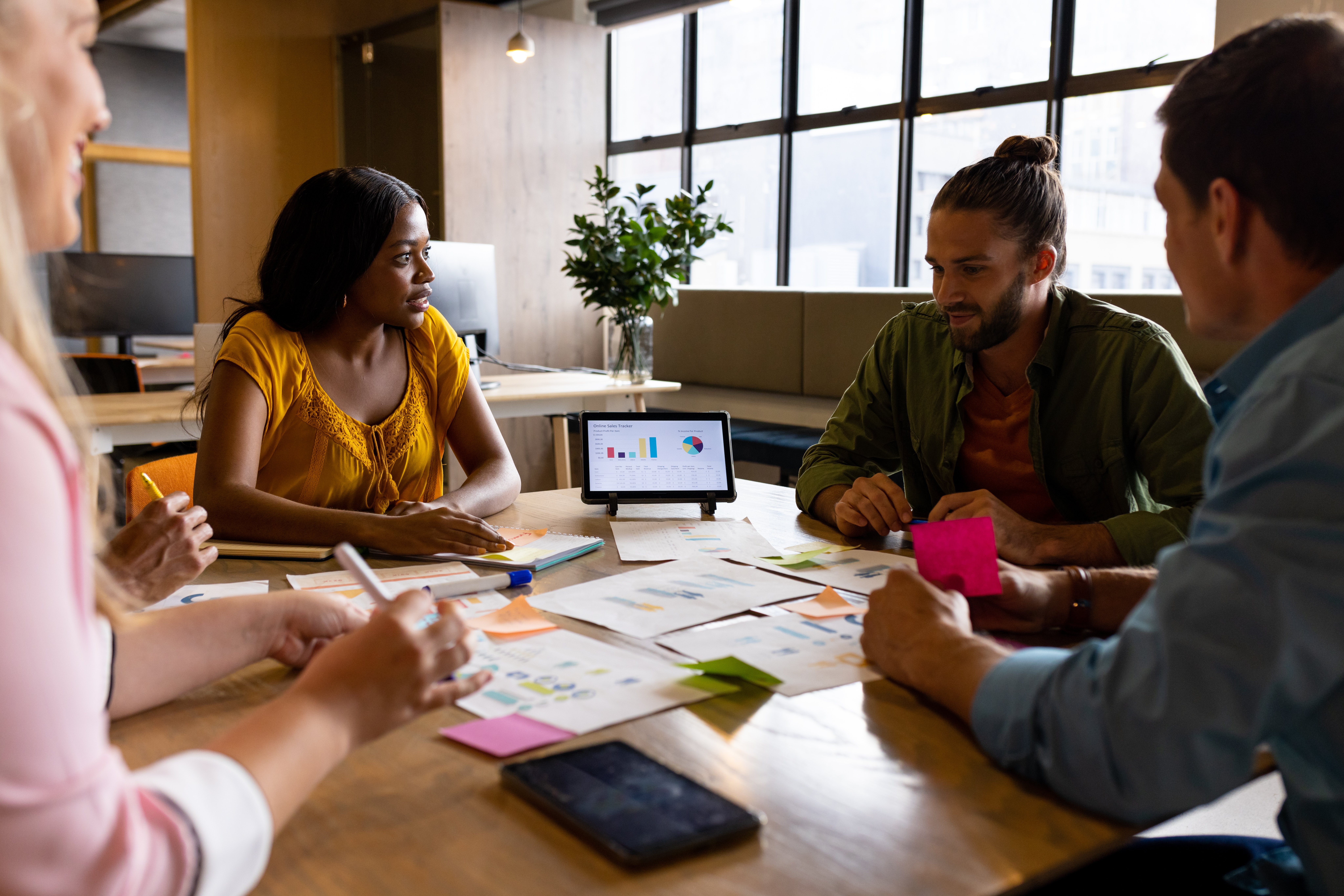 Creative colleagues discussing brand strategy around a table